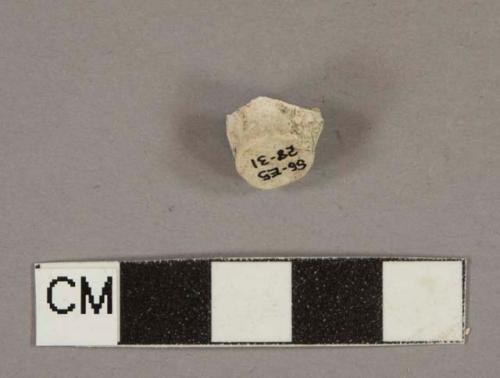 White kaolin pipe foot fragment, stamped with "B" and harp