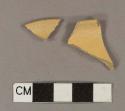 Undecorated yellowware rim sherds; two sherds crossmend