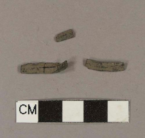 Black synthetic fragments; three fragments crossmend