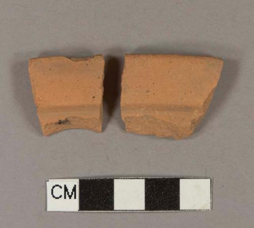 Unglazed, undecorated redware rim sherds; likely flowerpot rim; two sherds crossmend