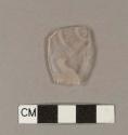 Etched colorless bottle glass fragment