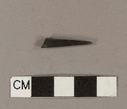 Black synthetic fragment; possible comb tooth