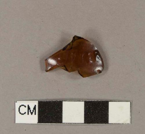 Glass, amber bottle glass fragment with embossed letters "LITTER"