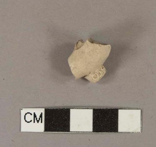 Smoked pipe bowl and heel fragment; heel stamped on either side with "[crown] T" and "[crown] D"