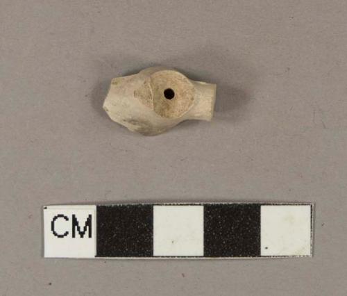 Unsmoked pipe bowl and heel fragment; heel marked on both sides with illegible marks