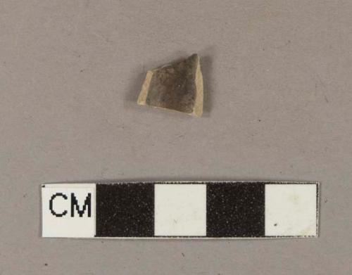 Smoked pipe bowl fragment with incised decoration