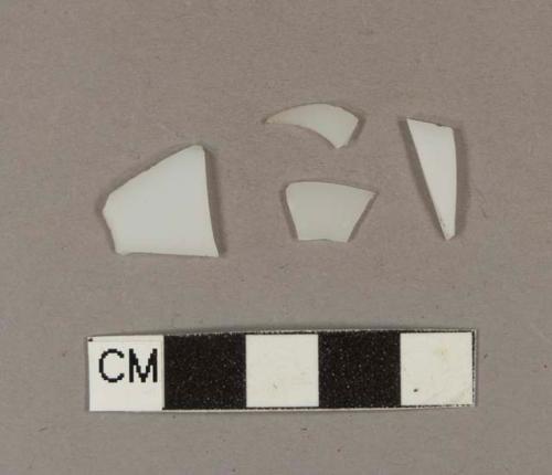 Milk white bottle glass fragments; two fragments crossmend