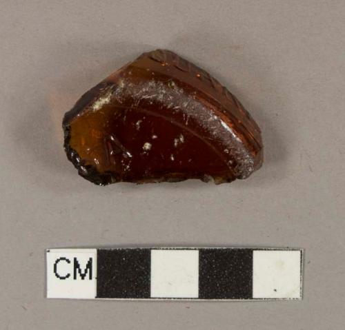 Glass, amber bottle glass base fragment; embossed with "6A" on the bottom; embossed with "QUAR" on the side