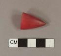 Red plastic cone-shaped piece