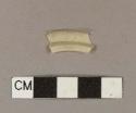 Cream-colored plastic fragment