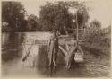 Two women with outrigger canoe