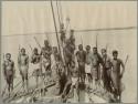 Men on boat posing with weapons