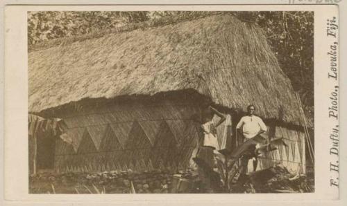 Men in front of house