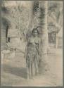 Young woman, Tuetiti, leaning against tree