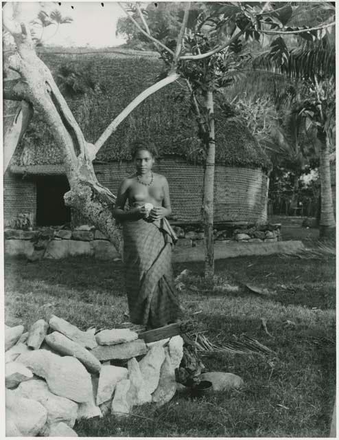 Woman standing outside a structure, Kambara, Fiji