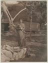 Woman standing outside a structure, Kambara, Fiji