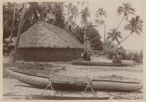 People and canoes in front of house on Murray Island