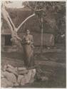 Woman standing outside a structure, Kambara, Fiji