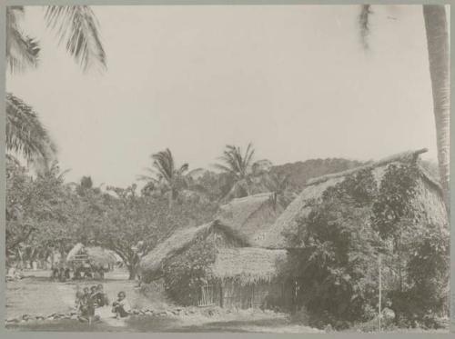 Village with people and thatched structures