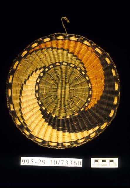 Plaited wicker circular plaque with swirl motif