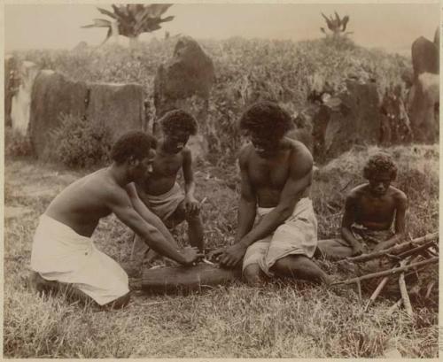 Group of men making fire