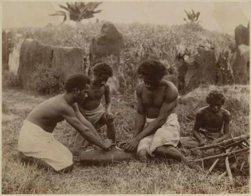 Group of men making fire