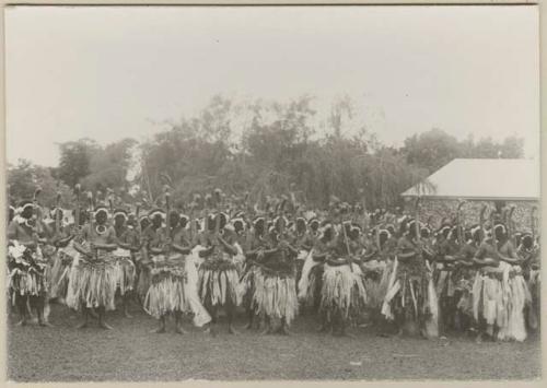 Large group of men in matching outfits dancing