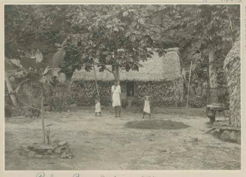 Man and children in yard