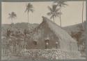 Two people in front of a house