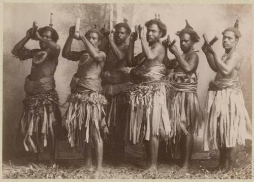 Group of male dancers with percussion instruments