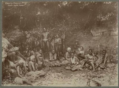 Group of people outside, some with weapons