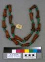 Necklace of turquoise-colored glass beads and  gazelles' knuckles