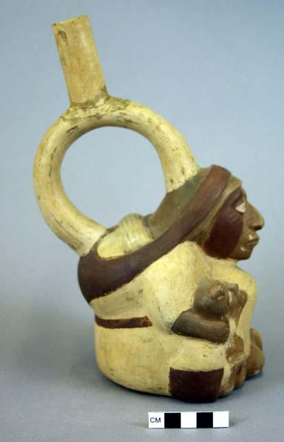 Ceramic bottle, stirrup spout, human effigy, molded, carrying child