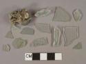 Light aqua flat glass and vessel body fragments, 1 fragment burned and conglomerate with slag