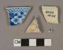 Blue on white transfer-decorated pearlware vessel rim and body fragments, white paste