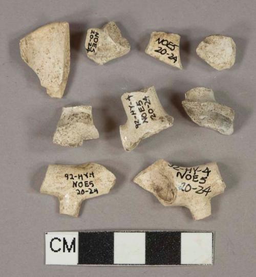 White undecorated kaolin pipe bowl fragments with foot fragments