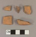 Unglazed, undecorated redware body sherds; two sherds crossmend