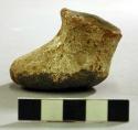 Brown on white pottery shoe