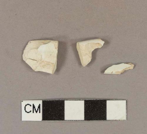 Undecorated whiteware rim sherds; two sherds crossmend