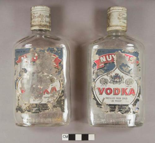 Colorless glass half pint vodka bottles with metal caps and paper labels