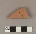 Unglazed, undecorated redware tile fragment