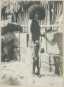 Man standing in front of wooden boxes and a structure