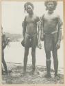 Two men standing on the shore