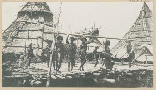 Men on pier, including Western man