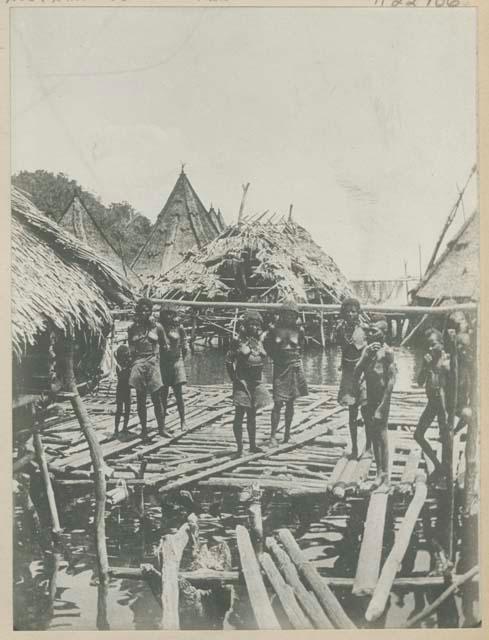 Group of people standing on pier