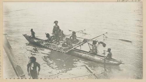 People in outrigger canoes