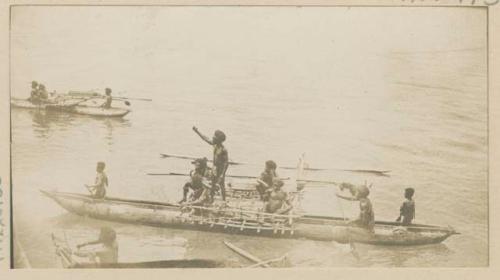 People in outrigger canoes