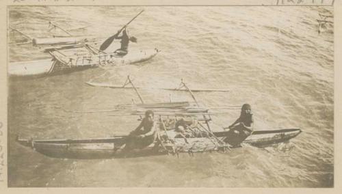 People in outrigger canoes