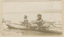 Two men in outrigger canoe
