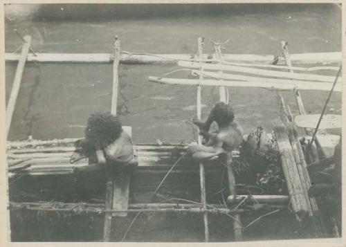 Two men in outrigger canoe